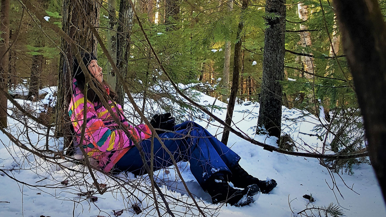 Woman Leaning Against Tree While Adirondack Sensory Snowshoeing